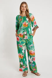 A model wearing the Akiko Pant in colour Sea (Green), from the front, showing the whole outfit