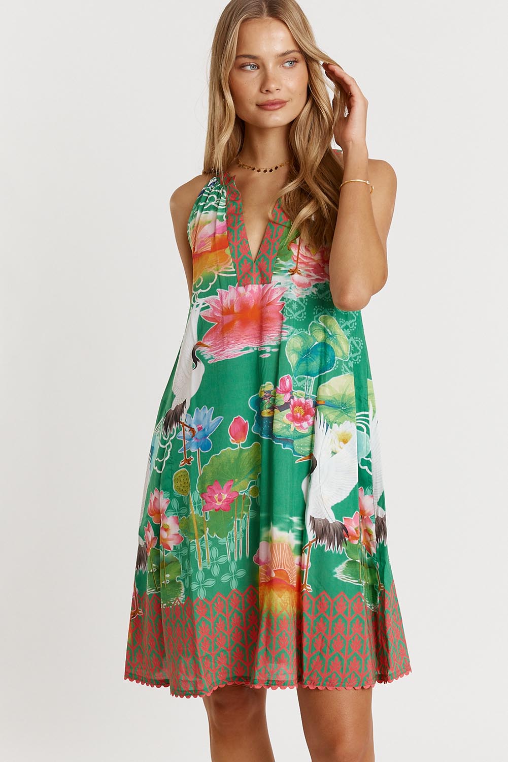 A model wearing the Akiko Sundress in colour Sea (Green), from the front, cropped image