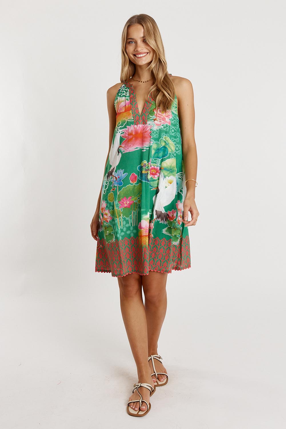 A model wearing the Akiko Sundress in colour Sea (Green), from the front, showing the whole outfit