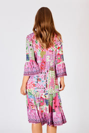 A model wearing the Aliah Midi Dress in colour Fuchsia (Pink), from the back