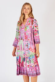 A model wearing the Aliah Midi Dress in colour Fuchsia (Pink), from the front, cropped image