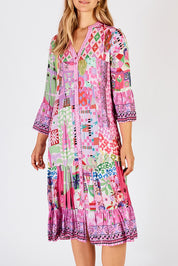 A model wearing the Aliah Midi Dress in colour Fuchsia (Pink), from the front, cropped image