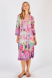 A model wearing the Aliah Midi Dress in colour Fuchsia (Pink), from the front, showing the whole outfit