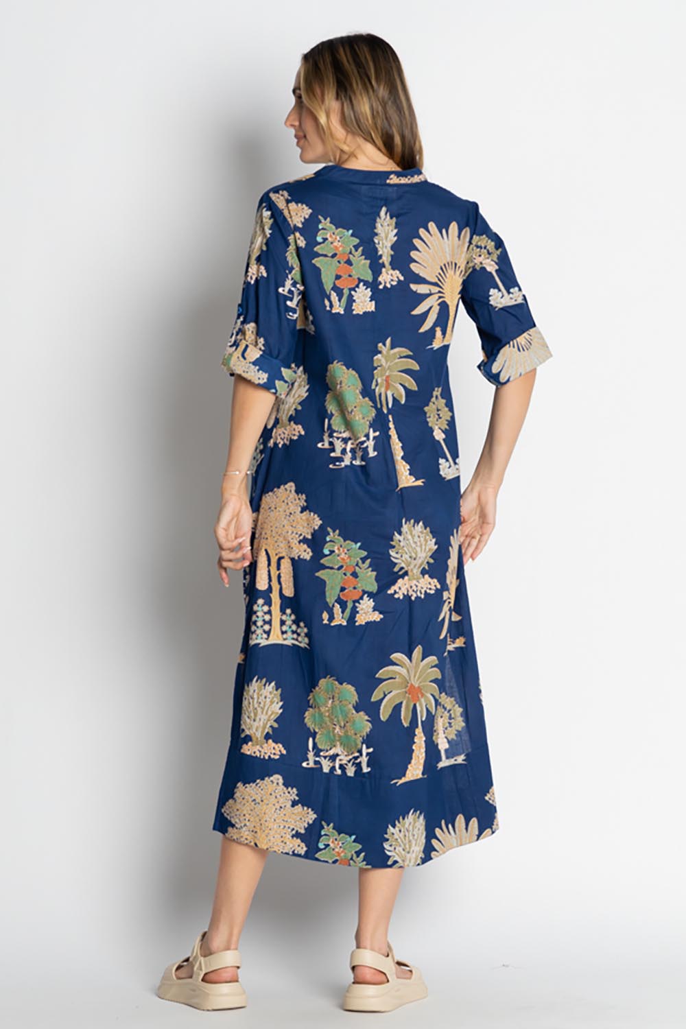 A model wearing the Amrita Cotton Midi Dress in colour Navy (Blue), from the back