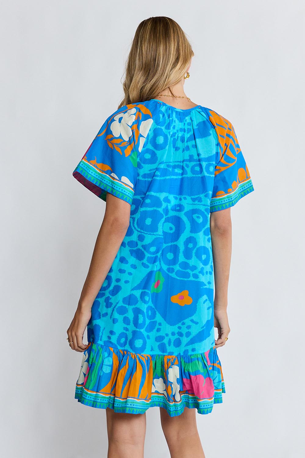 Model Genericm wearing size sample of the Ashanti Dress – Ocean in colour Ocean, from the back