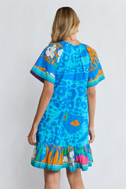 Model Genericm wearing size sample of the Ashanti Dress – Ocean in colour Ocean, from the back