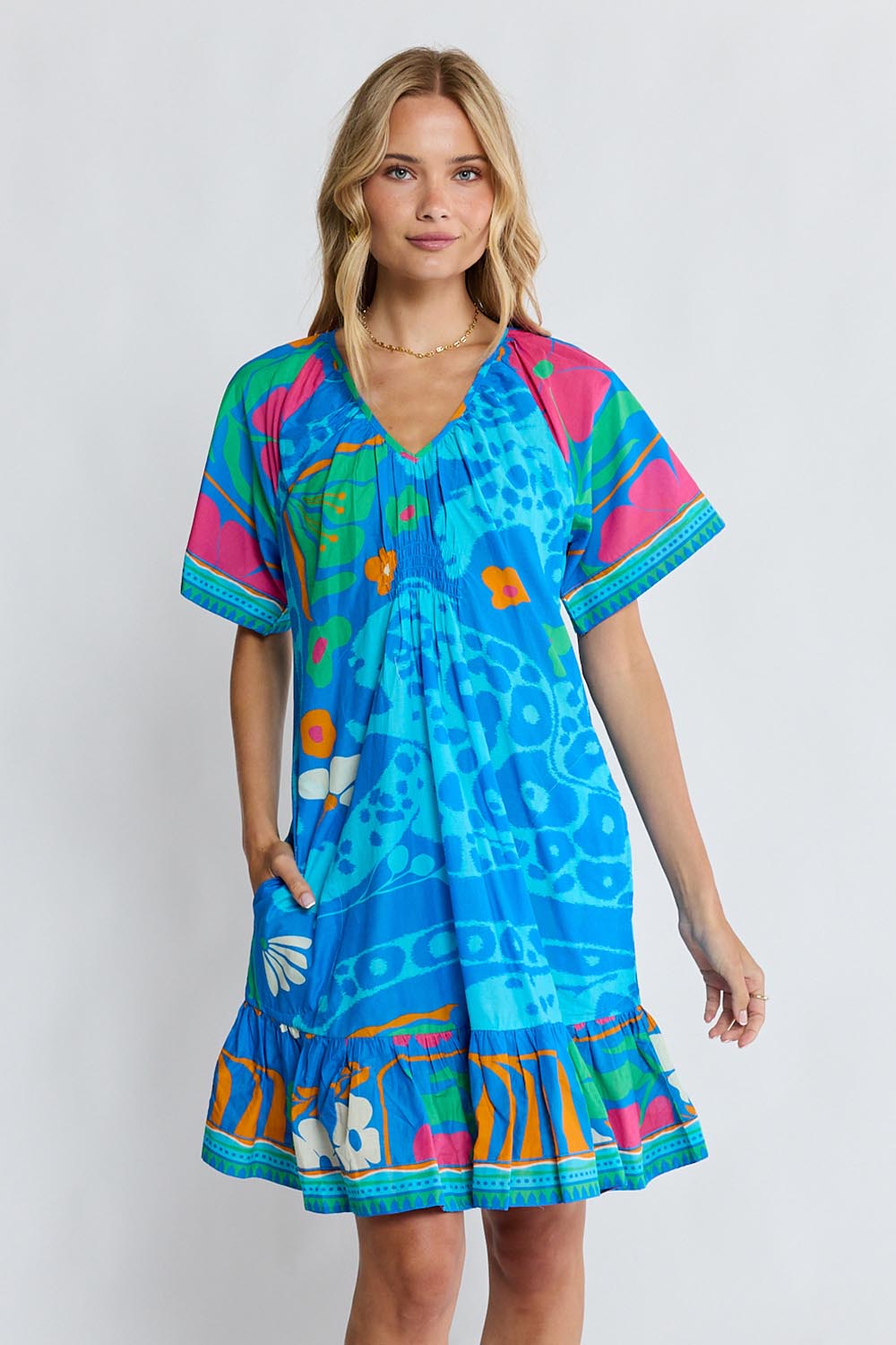 Model Genericm wearing size sample of the Ashanti Dress – Ocean in colour Ocean, in a cropped view