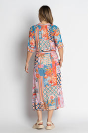 A model wearing the Asmara Shirtdress in colour Ocean, from the back