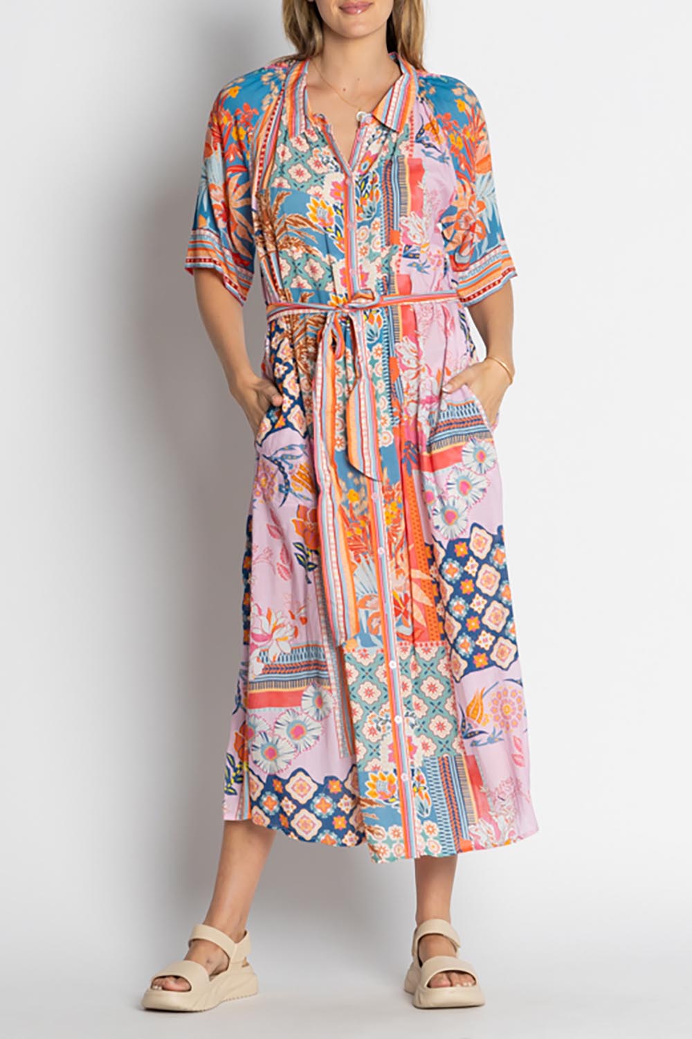 A model wearing the Asmara Shirtdress in colour Ocean, from the front, cropped image