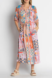 A model wearing the Asmara Shirtdress in colour Ocean, from the front, cropped image