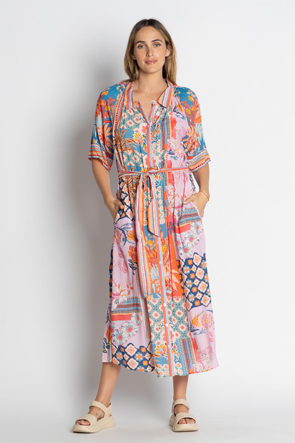 A model wearing the Asmara Shirtdress in colour Ocean, from the front, showing the whole outfit