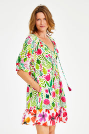 Model Naomi wearing size S of the Austin Shirred Dress in colour Sea (Green), from the front, cropped image