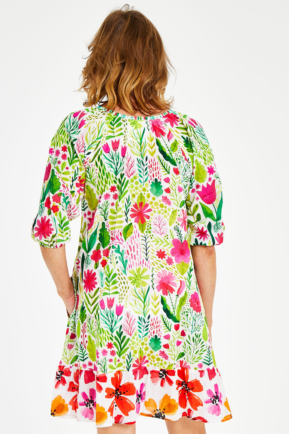Model Naomi wearing size S of the Austin Shirred Dress in colour Sea (Green), from the front, cropped image