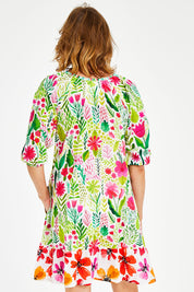 Model Naomi wearing size S of the Austin Shirred Dress in colour Sea (Green), from the front, cropped image