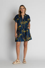 A model wearing the Badira Cotton Dress in colour Navy (Blue), from the front, showing the whole outfit