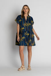 A model wearing the Badira Cotton Dress in colour Navy (Blue), from the front, showing the whole outfit