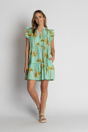 A model wearing the Badira Cotton Ruffle Dress in colour Mist (Green), from the front, showing the whole outfit