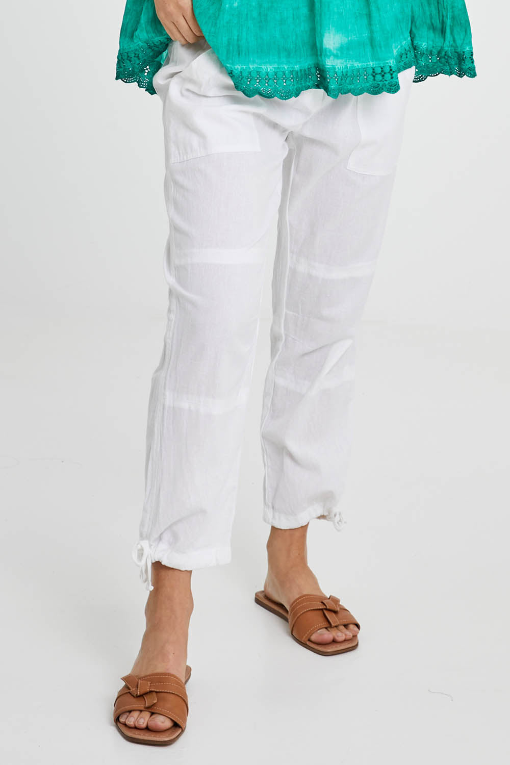 Model Katie wearing size M of the Beach Pant in colour White (White), from the front, cropped image