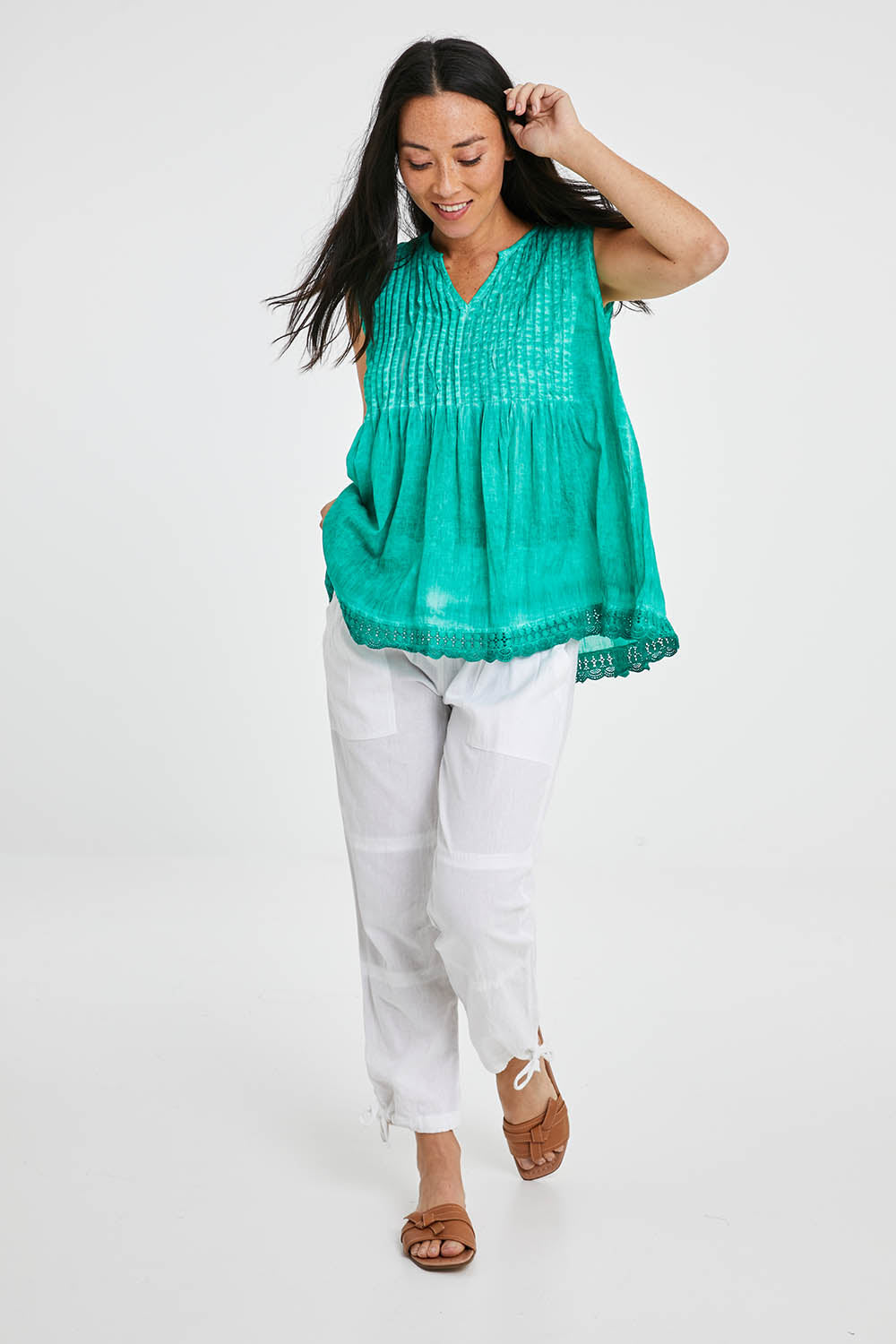 Model Katie wearing size M of the Beach Pant in colour White (White), from the front, showing the whole outfit