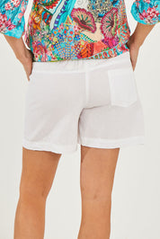 Model Georgia wearing size S of the Beach Short in colour White (White), from the back
