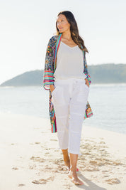Model Alex wearing size S of the Beach Pant in colour White (White), from the front, showing the whole outfit