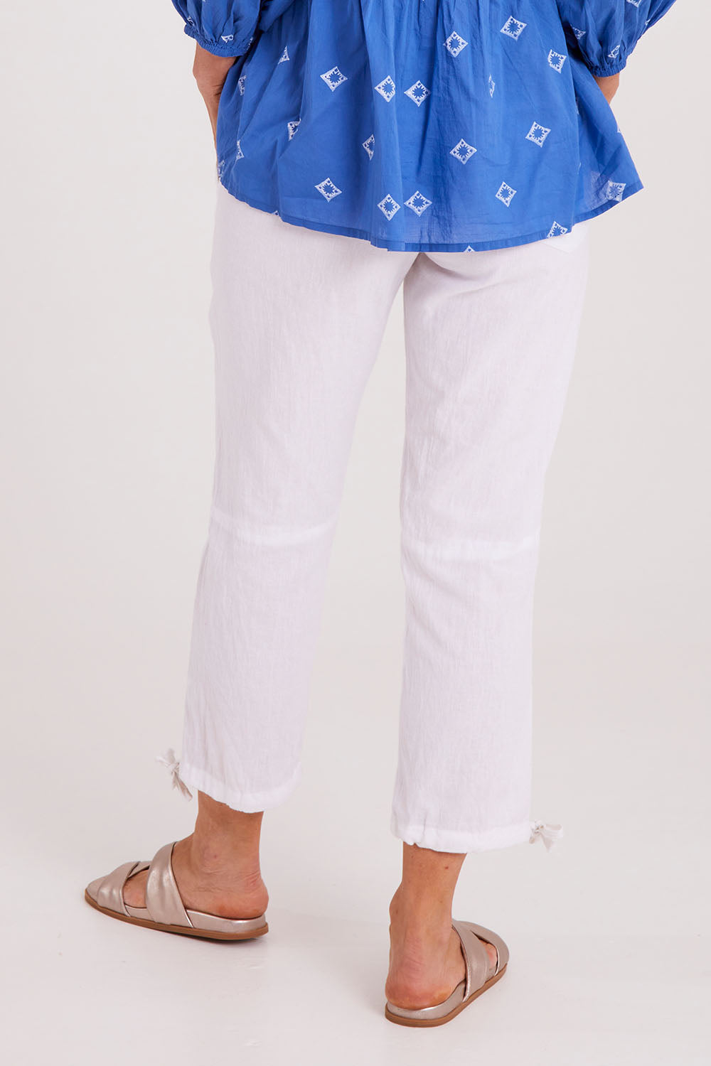 Model Luisa wearing size S of the Beach Pant in colour White (White), from the back