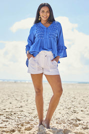 Model Eshan wearing size 10 of the Beach Short – White in colour White, from the front