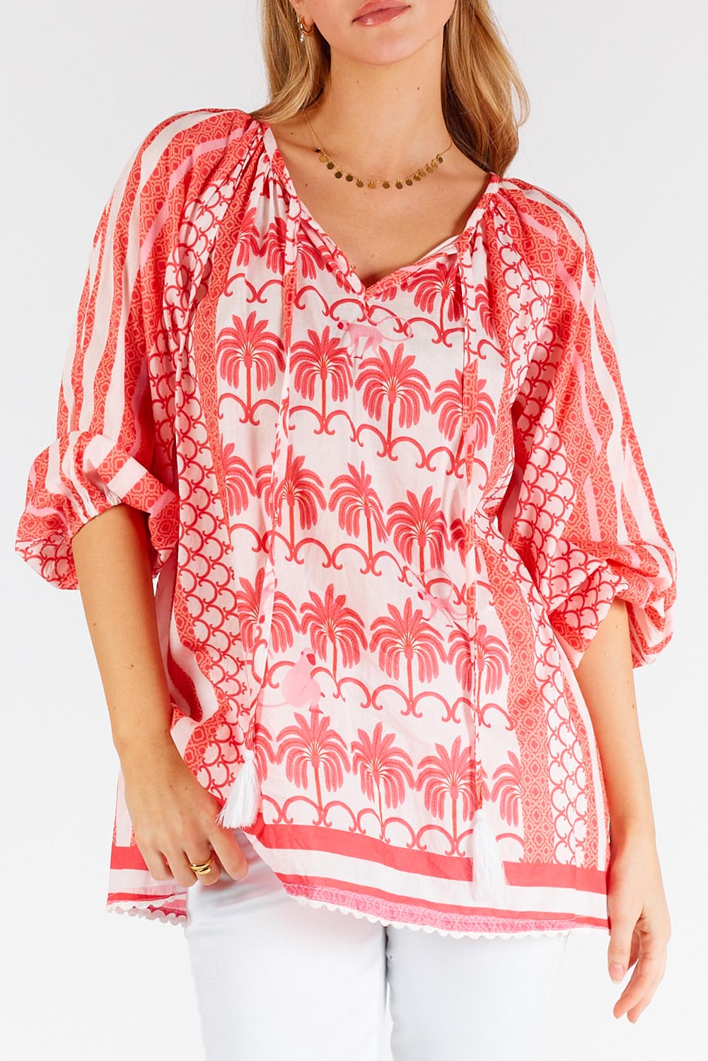 A model wearing the Blakely Cotton Top in colour Melon (Pink), from the front, cropped image
