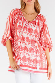A model wearing the Blakely Cotton Top in colour Melon (Pink), from the front, cropped image