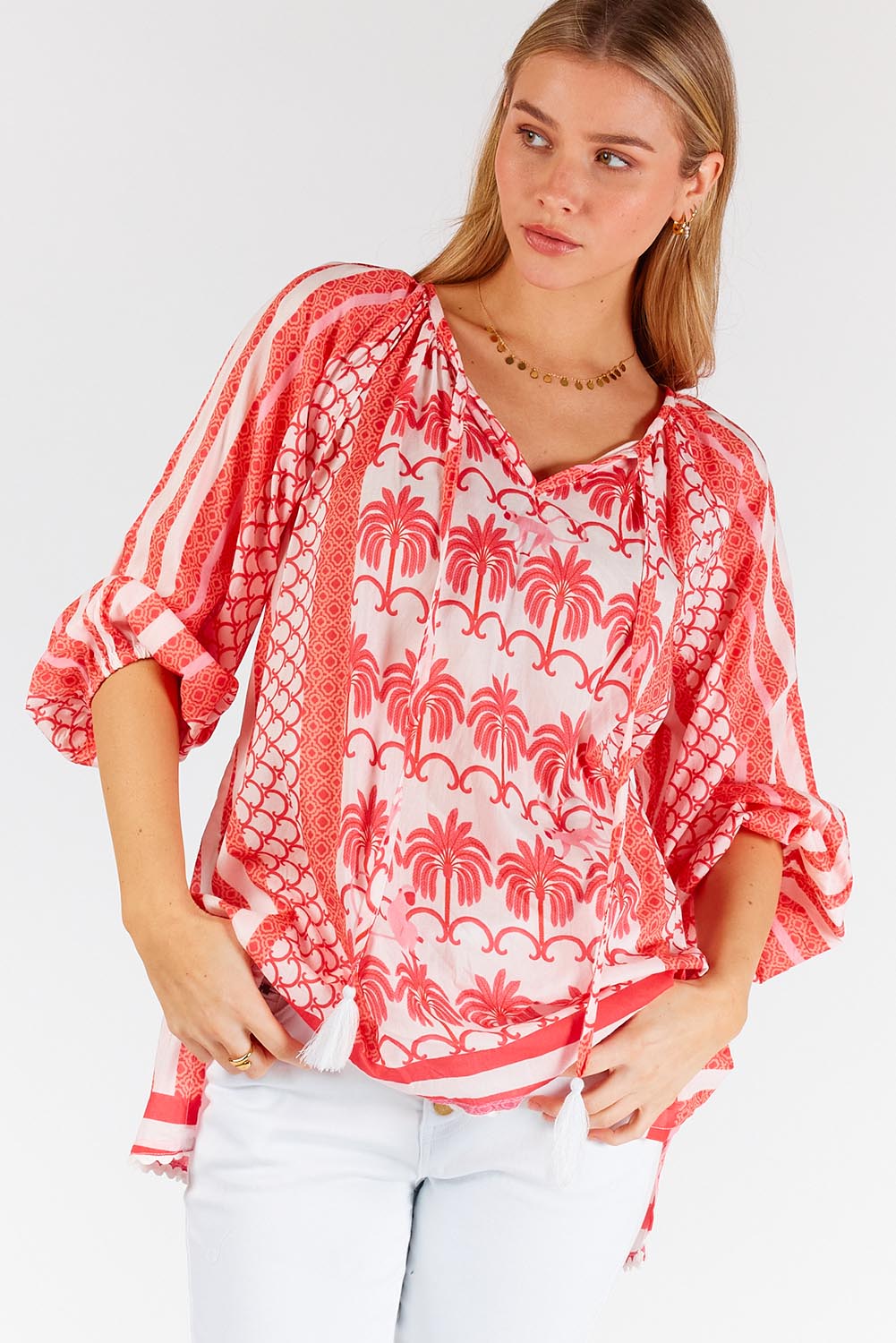 A model wearing the Blakely Cotton Top in colour Melon (Pink), from the front, cropped image