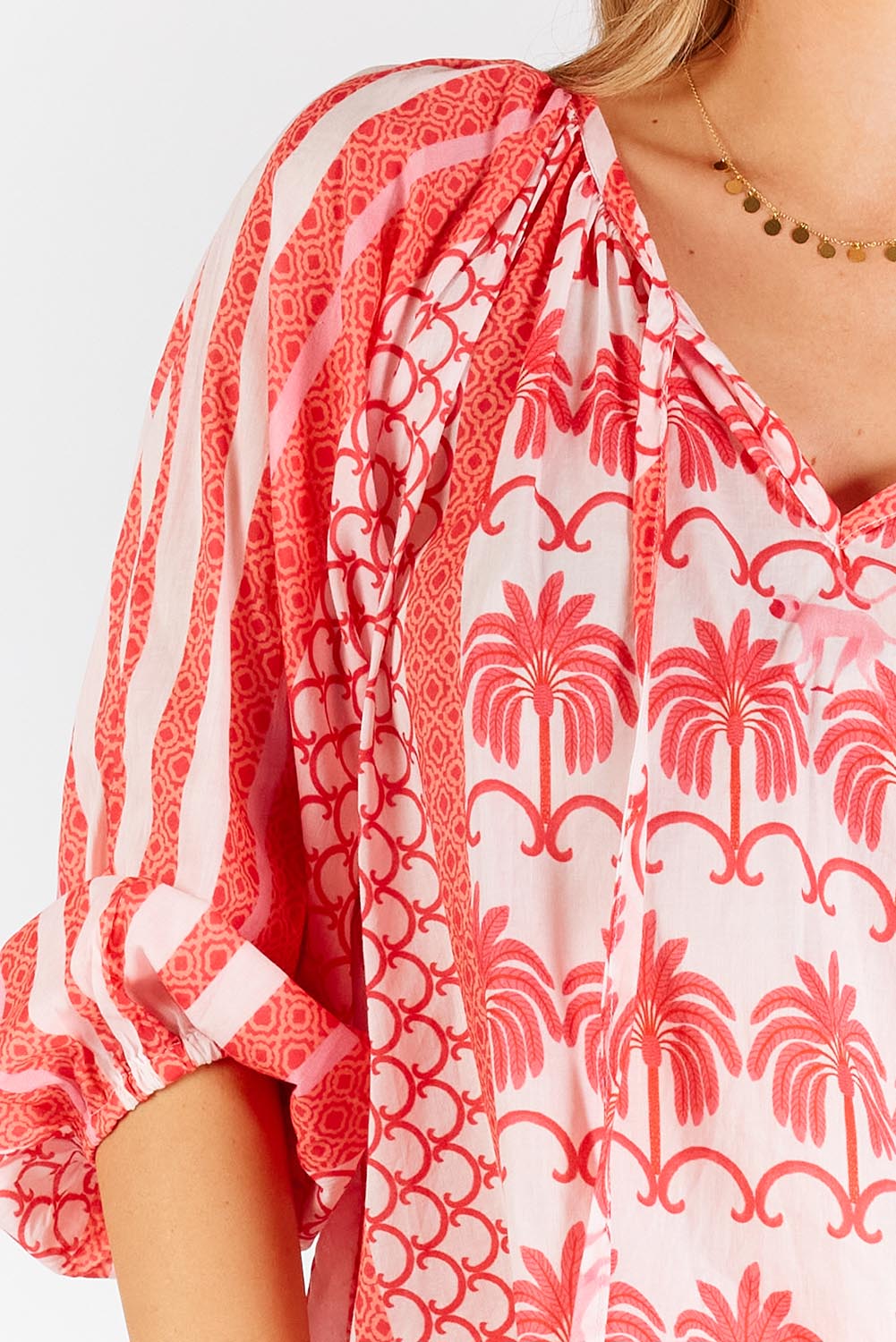 A model wearing the Blakely Cotton Top in colour Melon (Pink), from the front, cropped image