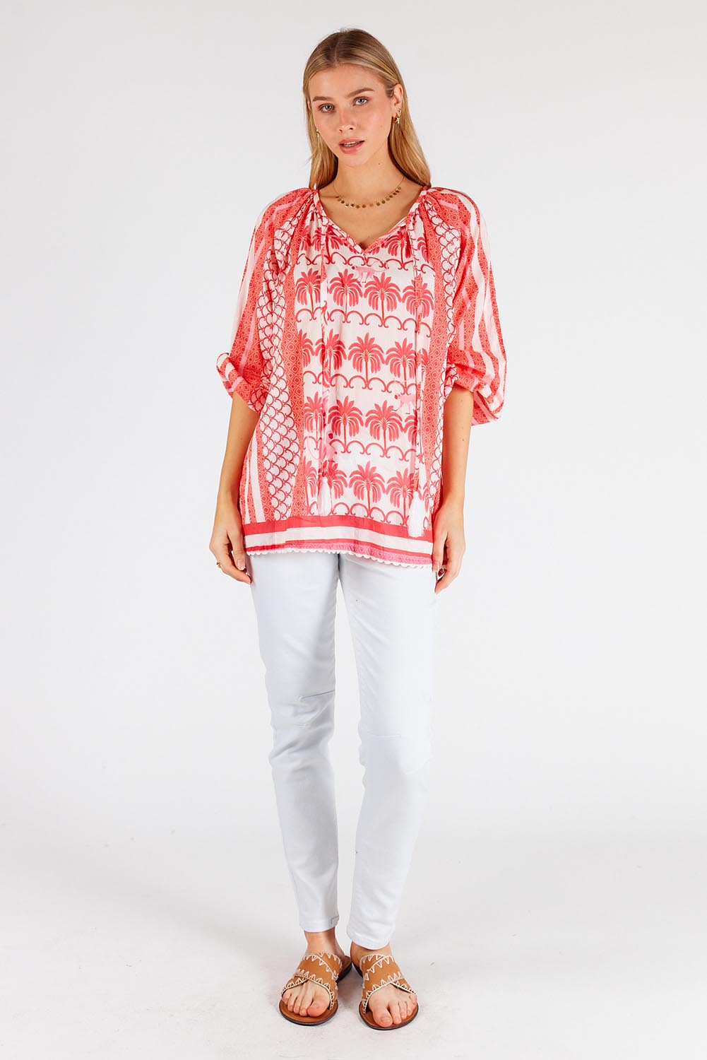 A model wearing the Blakely Cotton Top in colour Melon (Pink), from the front, showing the whole outfit