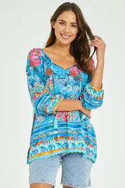Model Madeline wearing size S of the Carrie Top in colour Sky (Blue), from the front, cropped image