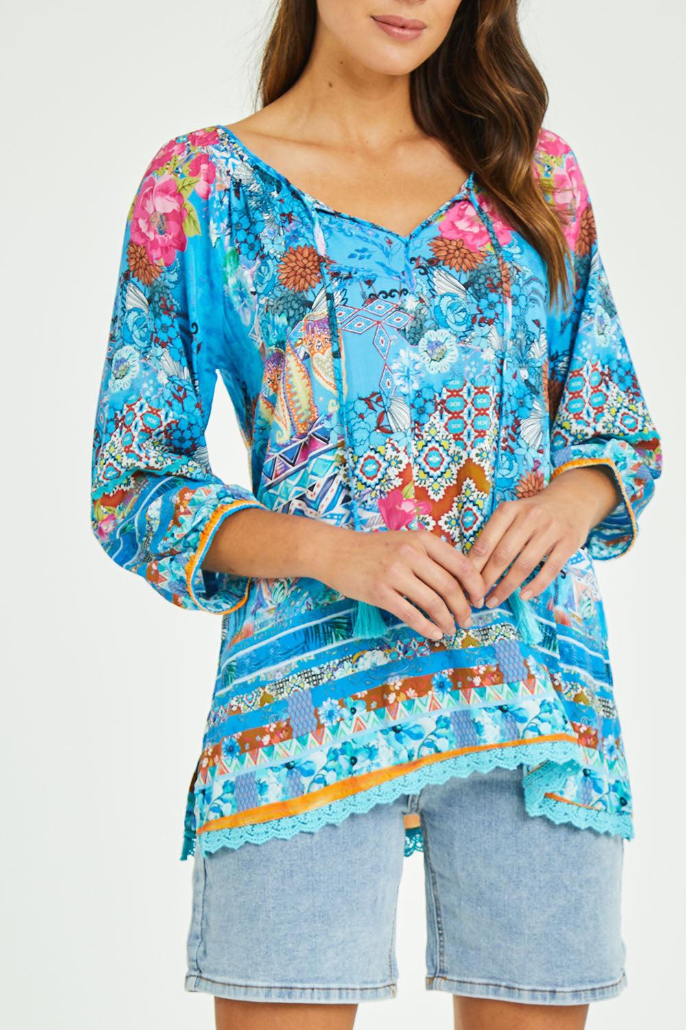 Model Madeline wearing size S of the Carrie Top in colour Sky (Blue), from the front, cropped image