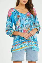 Model Madeline wearing size S of the Carrie Top in colour Sky (Blue), from the front, cropped image