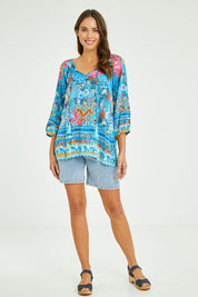 Model Madeline wearing size S of the Carrie Top in colour Sky (Blue), from the front, showing the whole outfit