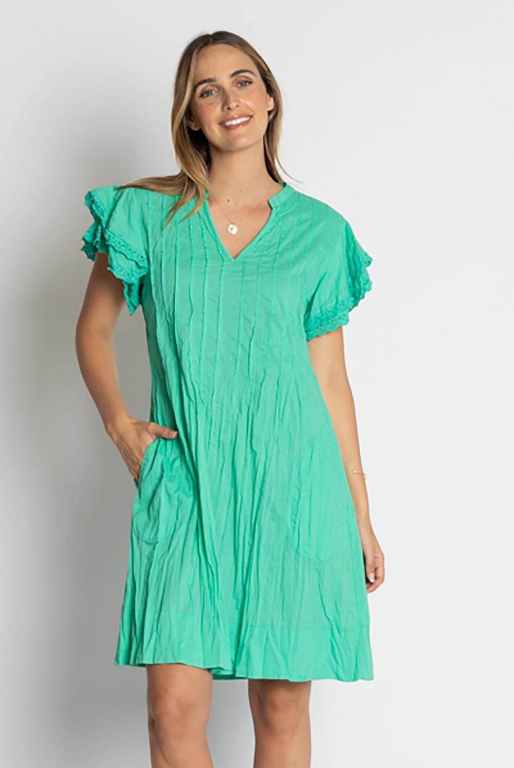 A model wearing the Celeste Ruffle Cotton Dress in colour Sea (Blue), from the front, cropped image