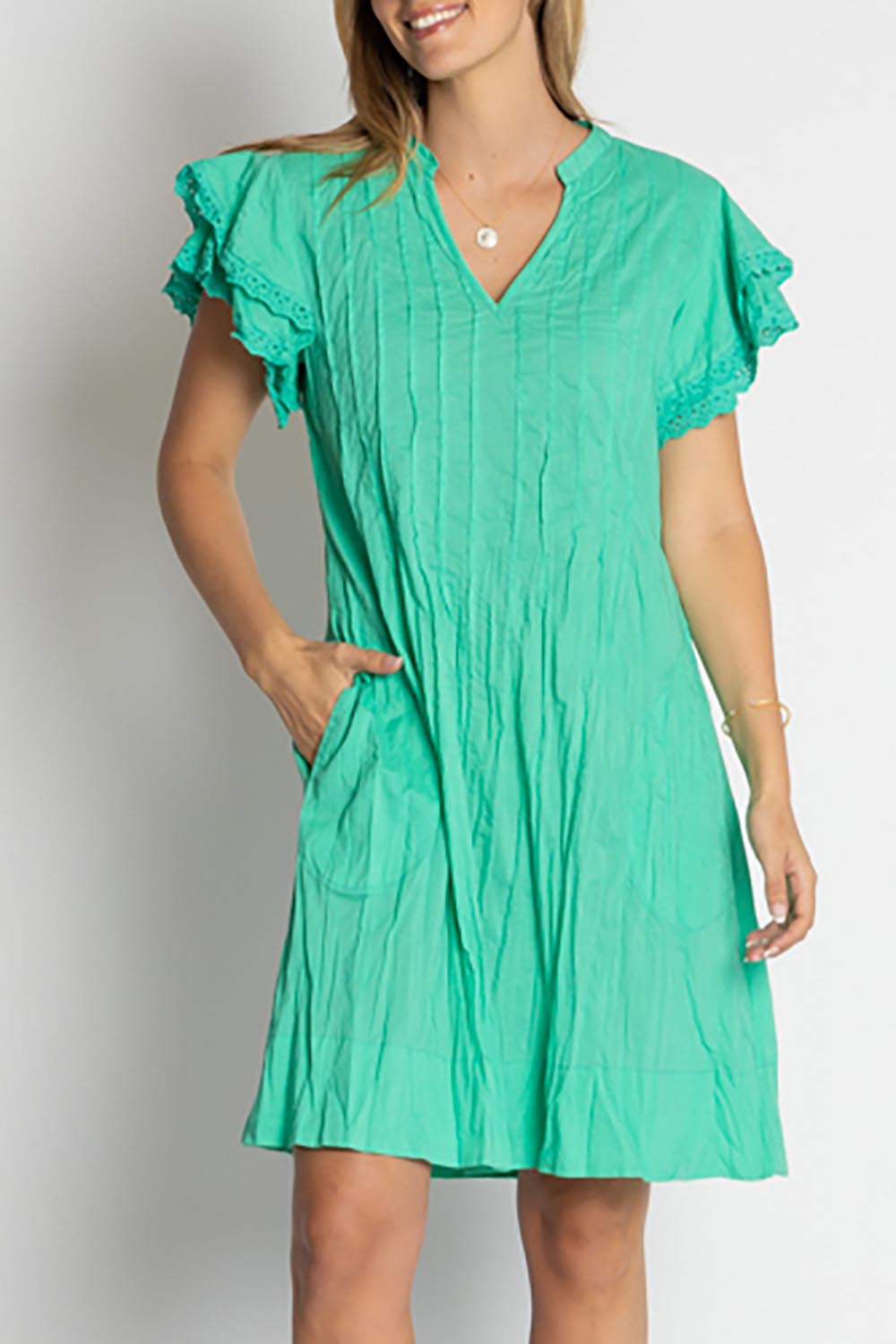 A model wearing the Celeste Ruffle Cotton Dress in colour Sea (Blue), from the front, cropped image