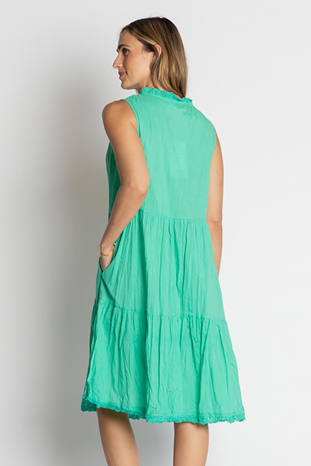A model wearing the Celeste Sleeveless Cotton Dress in colour Sea (Blue), from the back