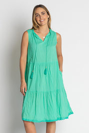 A model wearing the Celeste Sleeveless Cotton Dress in colour Sea (Blue), from the front, cropped image