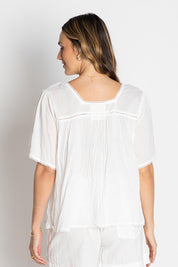 A model wearing the Celeste Cropped Cotton Top in colour White (White), from the back