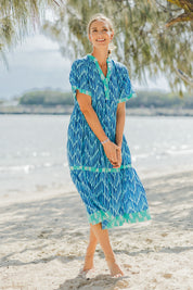 Model Riina wearing size S of the Chevron Midi Dress in colour Ocean (Blue), from the front, showing the whole outfit
