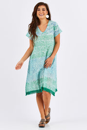 Model Chesska wearing size S of the Delphi Dress in colour Sea (Green), from the front, showing the whole outfit