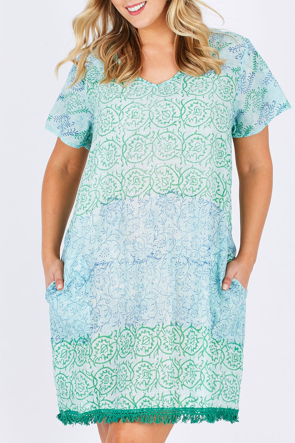 Model Jess wearing size L of the Delphi Dress in colour Sea (Green), from the front, cropped image