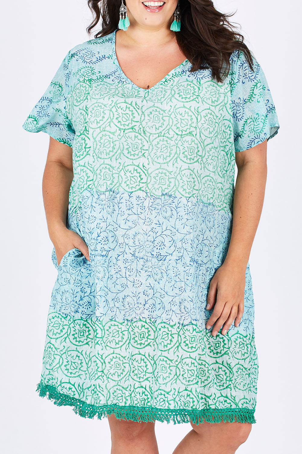 Model Mae wearing size XXL of the Delphi Dress in colour Sea (Green), from the front, cropped image