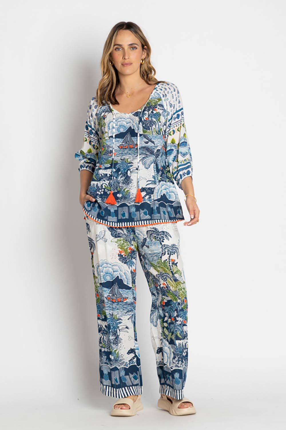 A model wearing the Dita Wide Leg Pant in colour Ocean (Blue), from the front, showing the whole outfit