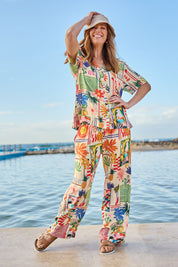 Model Katie wearing size S of the Ellery Pant in colour Cream, from the front, showing the whole outfit