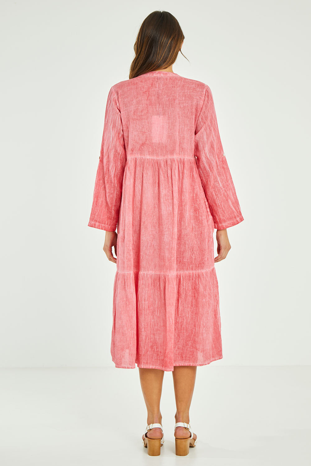 Model Madeline wearing size S of the Ethel Midi Dress in colour Melon (Pink), from the back