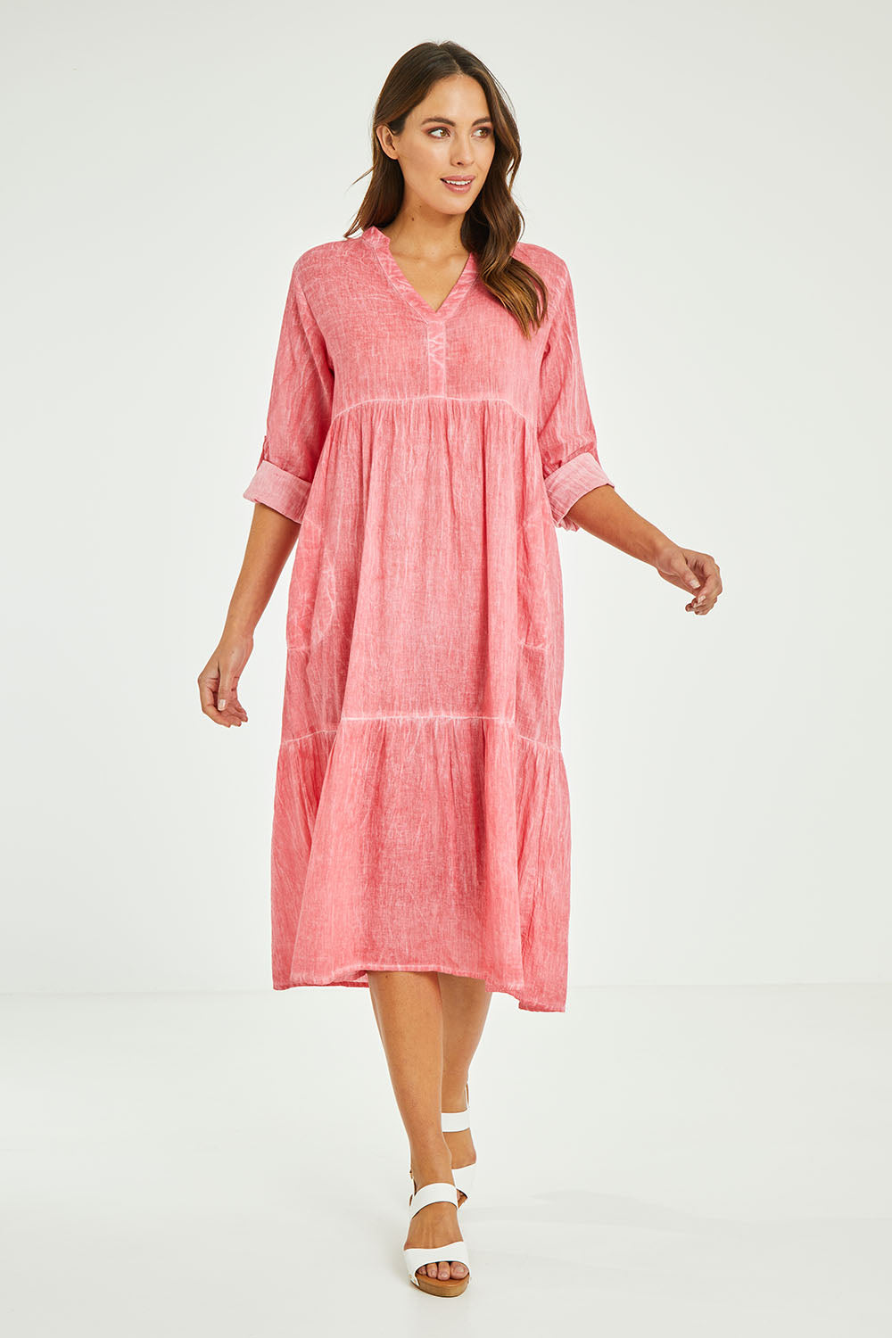 Model Madeline wearing size S of the Ethel Midi Dress in colour Melon (Pink), from the front, showing the whole outfit