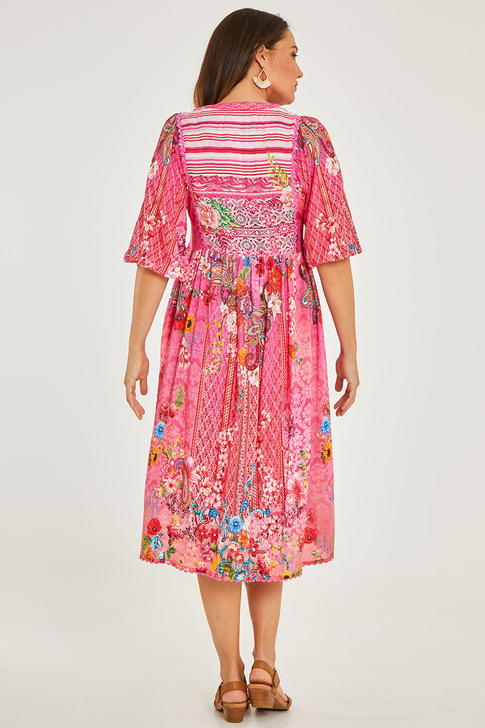 Model Georgia wearing size S of the Frankie Midi Dress in colour Melon (Pink), from the back